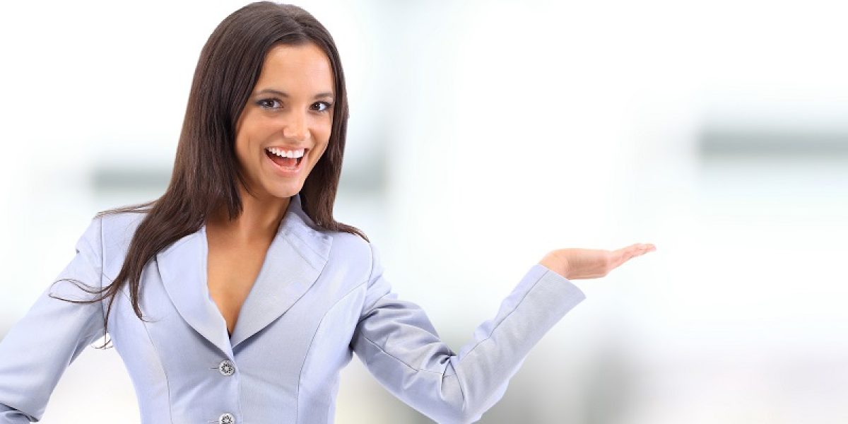 Young attractive woman holds palm for blank ad space